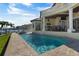 Beautiful pool with an outdoor kitchen and dining area overlooking the waterfront at 7986 9Th S Ave, St Petersburg, FL 33707