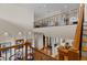 Elegant staircase with wrought iron railings, wooden treads, and a view of the open foyer below at 7986 9Th S Ave, St Petersburg, FL 33707