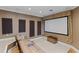 Entertainment area featuring a projector screen, comfortable seating, and dim lighting for an immersive viewing experience at 7986 9Th S Ave, St Petersburg, FL 33707