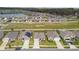 Spacious suburban neighborhood with manicured lawns, a scenic pond, and organized street layouts at 8034 Broad Pointe Dr, Zephyrhills, FL 33540