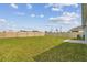 A spacious backyard featuring lush green grass and a privacy fence, perfect for outdoor activities at 8034 Broad Pointe Dr, Zephyrhills, FL 33540