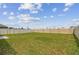 Large, well-manicured backyard with lush green lawn enclosed by a sturdy privacy fence, perfect for outdoor activities at 8034 Broad Pointe Dr, Zephyrhills, FL 33540