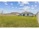 Backyard view showcasing a spacious lawn at 8034 Broad Pointe Dr, Zephyrhills, FL 33540