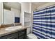 Bathroom featuring dark brown cabinets and a shower and tub combo at 8034 Broad Pointe Dr, Zephyrhills, FL 33540