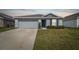Charming single-story home features a two-car garage, manicured lawn and a cozy front entrance at 8034 Broad Pointe Dr, Zephyrhills, FL 33540