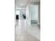 Bright hallway with tile flooring, neutral walls, and open doorways into other living spaces at 8034 Broad Pointe Dr, Zephyrhills, FL 33540