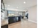 Modern kitchen with stainless appliances seamlessly flows into a cozy living area at 8034 Broad Pointe Dr, Zephyrhills, FL 33540