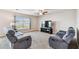 Cozy living room with neutral walls, carpet, ceiling fan and a large window offering ample light at 8034 Broad Pointe Dr, Zephyrhills, FL 33540