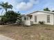 Single story home with neutral paint, simple landscaping, and a concrete porch and a paver driveway at 9427 Wolcott Ln, Port Richey, FL 34668