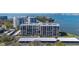 Aerial view of condo complex with parking and waterfront views, providing an exclusive residential experience at 100 Oakmont Ln # 112, Belleair, FL 33756