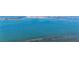 Beautiful aerial view of a sparkling blue waterfront with the city skyline in the distance at 100 Oakmont Ln # 112, Belleair, FL 33756