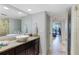 Stylish bathroom featuring a vessel sink, granite counters, and a doorway to the bedroom at 100 Oakmont Ln # 112, Belleair, FL 33756