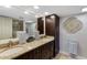 Elegant bathroom features double vanity, granite countertops, and decorative wall art at 100 Oakmont Ln # 112, Belleair, FL 33756