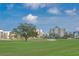 Expansive golf course view showcasing meticulously manicured greens and residential buildings at 100 Oakmont Ln # 112, Belleair, FL 33756