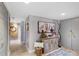 Hallway with decorative table, art, and mirrors that enhance the living space at 100 Oakmont Ln # 112, Belleair, FL 33756