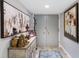 Hallway with neutral walls, tile floors, decorative table, and charming artwork at 100 Oakmont Ln # 112, Belleair, FL 33756