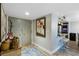 Well-lit entryway with stylish decor, modern art, and a glimpse into the kitchen area at 100 Oakmont Ln # 112, Belleair, FL 33756