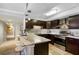 Modern kitchen featuring a stylish island, stainless steel appliances, and granite countertops at 100 Oakmont Ln # 112, Belleair, FL 33756