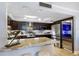 Renovated kitchen with stainless appliances, dark wood cabinets, and breakfast bar with counter seating at 100 Oakmont Ln # 112, Belleair, FL 33756