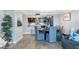 Open-concept living area flowing into a dining space with ample natural light and stylish decor at 100 Oakmont Ln # 112, Belleair, FL 33756