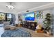 Comfortable living room with entertainment center, natural light, and lots of seating at 100 Oakmont Ln # 112, Belleair, FL 33756