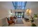 A grand lobby with high ceilings, elegant chandelier, comfortable seating, and natural light at 100 Oakmont Ln # 112, Belleair, FL 33756
