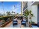Relaxing patio area with lovely views of the water, potted plants, and comfortable seating at 100 Oakmont Ln # 112, Belleair, FL 33756