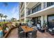 Inviting waterfront patio featuring a dining table and a relaxing hanging chair at 100 Oakmont Ln # 112, Belleair, FL 33756