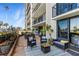 Inviting waterfront patio featuring multiple seating areas with plants and ocean views at 100 Oakmont Ln # 112, Belleair, FL 33756