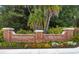 Entrance sign to Belleair Country Club and Belleview Inn with colorful flowerbed at 100 Oakmont Ln # 112, Belleair, FL 33756