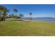 Scenic waterfront view features a lush green lawn with city views in the distance at 100 Oakmont Ln # 112, Belleair, FL 33756