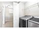 Laundry room featuring side by side washer and dryer and wire shelving at 10819 Kensington Park Ave, Riverview, FL 33578