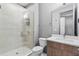Bathroom featuring glass shower, tiled walls, and a vanity with sink and mirror at 1110 25Th N St, St Petersburg, FL 33713