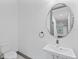 Modern half-bathroom with floating sink, round mirror, and sleek fixtures at 1110 25Th N St, St Petersburg, FL 33713