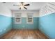 Bedroom with blue walls and a ceiling fan; two windows provide lots of natural light at 1110 25Th N St, St Petersburg, FL 33713