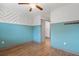 Bedroom with blue accent wall, stylish flooring, a ceiling fan, and a closet nearby at 1110 25Th N St, St Petersburg, FL 33713