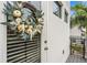 Front door adorned with a decorative wreath and a nearby palm tree at 1110 25Th N St, St Petersburg, FL 33713
