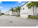 View of modern townhomes featuring two car garages, sidewalks, and lush landscaping at 1110 25Th N St, St Petersburg, FL 33713