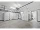 Clean two-car garage featuring high ceilings with installed storage racks and bright lighting at 1110 25Th N St, St Petersburg, FL 33713