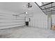 Clean two-car garage featuring high ceilings with installed storage racks and bright lighting at 1110 25Th N St, St Petersburg, FL 33713