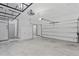 Clean two-car garage featuring high ceilings with installed storage racks and bright lighting at 1110 25Th N St, St Petersburg, FL 33713