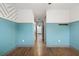 Bright hallway with wood floors, blue walls with white trim, and hallway leading into the other rooms at 1110 25Th N St, St Petersburg, FL 33713