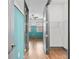 View of wood hallway between two rooms, one is a colorful bedroom and the other a closet at 1110 25Th N St, St Petersburg, FL 33713