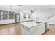 Bright kitchen with modern island, stainless steel sink, and white cabinets and countertops at 1110 25Th N St, St Petersburg, FL 33713
