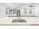 Bright kitchen with quartz countertops, modern faucet, stainless steel sink, and natural light from nearby windows at 1110 25Th N St, St Petersburg, FL 33713