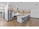 Bright kitchen featuring stainless steel appliances, a large center island with seating, and wood-look floors at 1110 25Th N St, St Petersburg, FL 33713