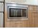 Built-in stainless steel microwave with digital display and light wood cabinets at 1110 25Th N St, St Petersburg, FL 33713