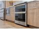 Stainless steel double oven and microwave with sleek wood cabinetry at 1110 25Th N St, St Petersburg, FL 33713