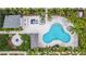 Aerial view of the community pool and lounging area surrounded by palm trees at 1110 25Th N St, St Petersburg, FL 33713