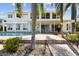 Spacious backyard with a pool, patio, and lush landscaping perfect for outdoor entertaining and relaxation at 119 Carlyle Cir, Palm Harbor, FL 34683